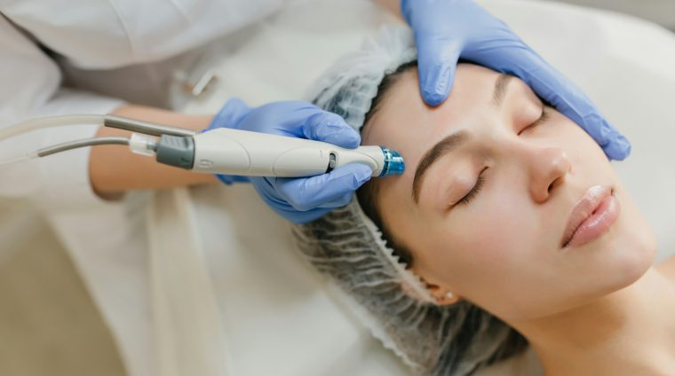 a woman getting a facial peel from a doctor