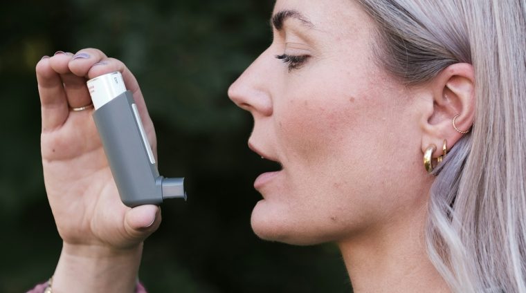 A woman holding a cell phone up to her face